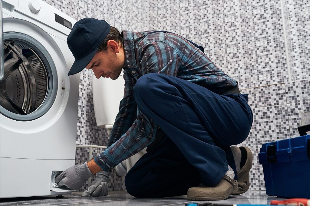 attantive-worker-working-man-plumber-bathroom-checking-work-wacher-mashine-close-up